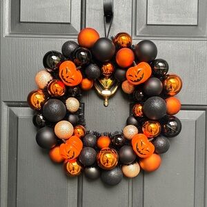 Festive Halloween Wreath with Orange and Black Ornaments